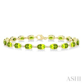 6X4 MM Oval Cut Peridot and 1/6 Ctw Round Cut Diamond Semi-Precious Tennis Bracelet in 10K Yellow Gold