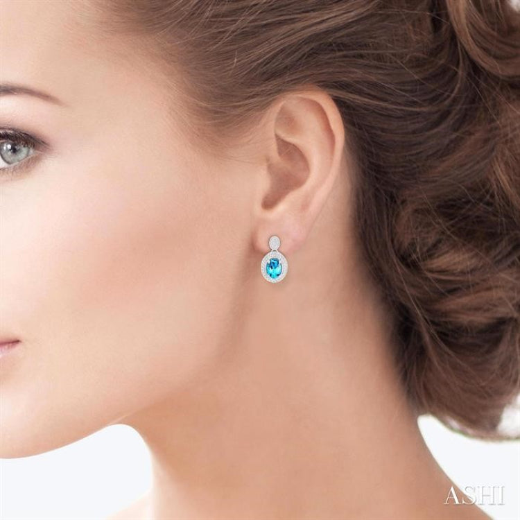 7X5 MM Oval Cut Blue Topaz and 1/20 Ctw Round Cut Diamond Semi-Precious Earring in Sterling Silver